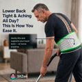 Man wearing the SitZen 4-in-1 lumbar support belt while vacuuming at home